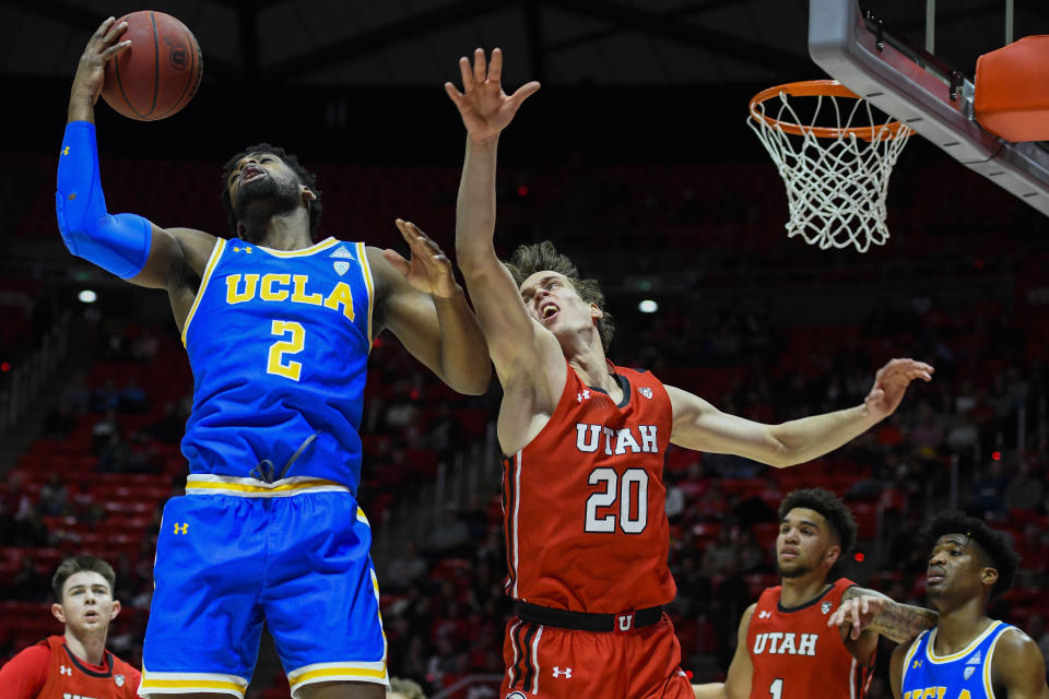 UCLA forward Cody Riley (2) grabs a rebound over Utah forward Mikael Jantunen (20) during the first half of an NCAA college basketball game Thursday, Feb. 20, 2020, in Salt Lake City. (AP Photo/Alex Goodlett)