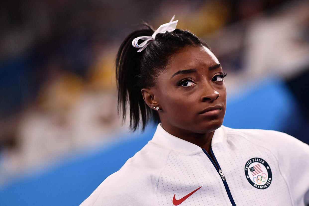 USA's Simone Biles reacts during the artistic gymnastics women's team final during the Tokyo 2020 Olympic Games at the Ariake Gymnastics Centre in Tokyo on July 27, 2021. (Photo by Loic VENANCE / AFP) (Photo by LOIC VENANCE/AFP via Getty Images)