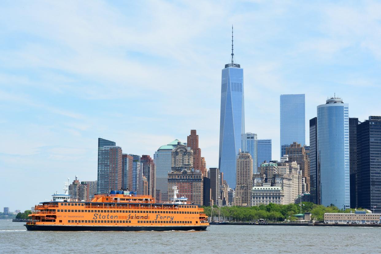 Staten Island Ferry pulling into New York Harbor with the Lower Manhattan skyline