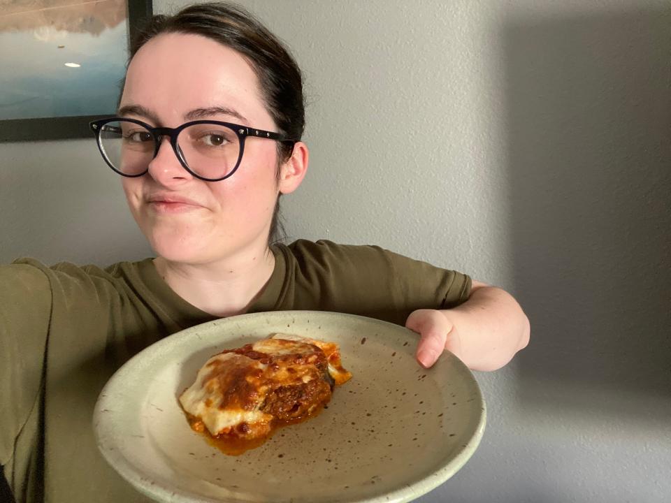 Paige holding an eggplant Parmesan made from Bobby Flay's recipe.