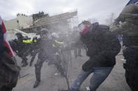 FILE - In this Jan. 6, 2021, file photo, supporters of then-President Donald Trump try to break through a police barrier at the Capitol in Washington. (AP Photo/Julio Cortez, File)