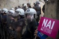 Riot policemen stand guard next to a small flag with the word "Yes" in Greek during a rally in front of the parliament building in Athens, Greece, June 30, 2015. REUTERS/Marko Djurica