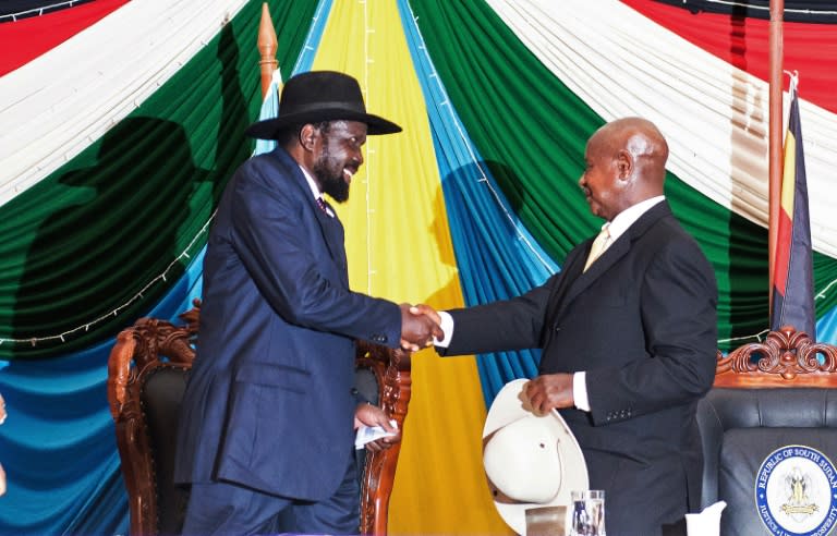 South Sudan's President Salva Kiir (left) shakes hands with Uganda's President Yoweri Museveni after signing a peace agreement in Juba, on August 26, 2015