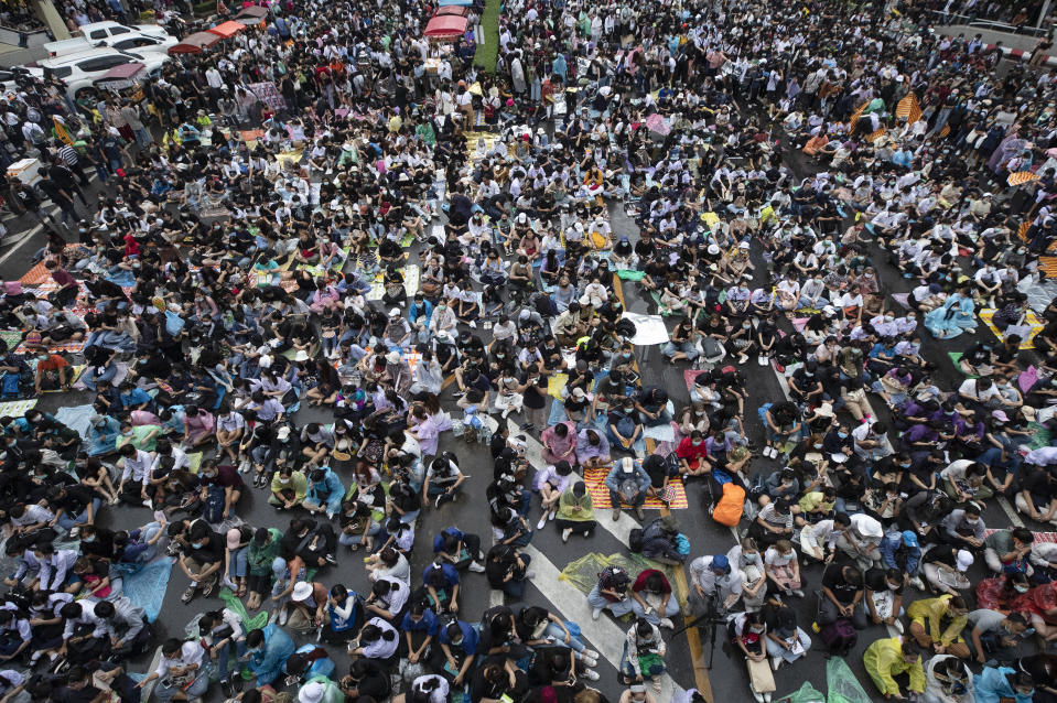 Hundreds of pro-democracy protesters gather in a business district in Bangkok, Thailand, Friday, Oct. 16, 2020. Thailand’s prime minister has rejected calls for his resignation as his government steps up efforts to stop student-led protesters from rallying in the capital for a second day in defiance of a strict state of emergency. (AP Photo/Sakchai Lalit)