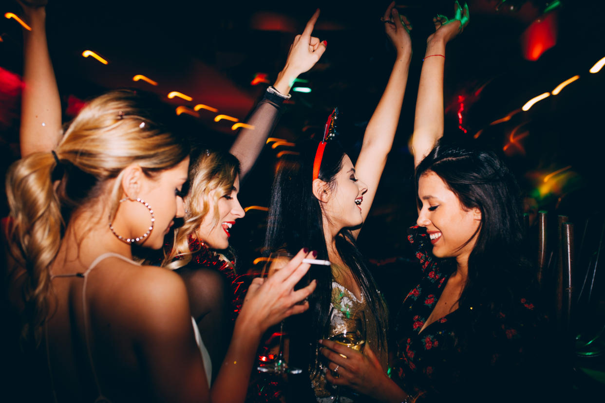 Female friends drinking wine and celebrating new year at the clu - Credit: Astarot/Adobe Stock