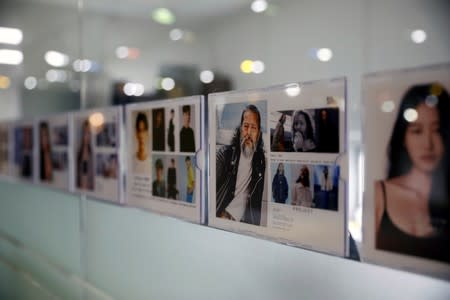 Profile picture of South Korean senior model Kim Chil-doo, 65-years-old, hangs on a glass wall at a model agency in Seoul