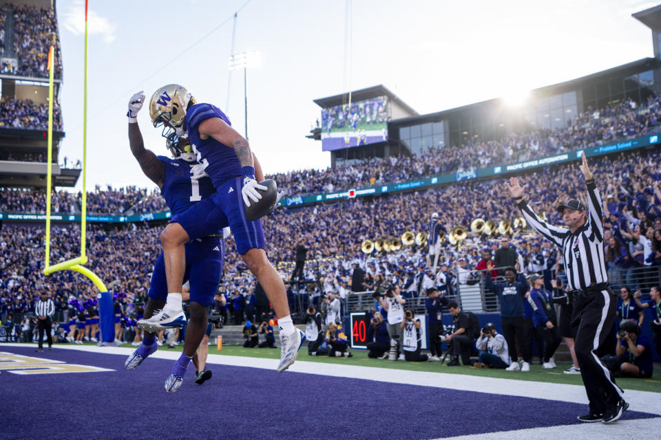 Washington wide receiver Denzel Boston, front, celebrates his touchdown with running back Jonah Coleman (1) during the first half of an NCAA college football game against Michigan, Saturday, Oct. 5, 2024, in Seattle. (AP Photo/Lindsey Wasson)