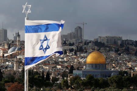 FILE PHOTO: An Israeli flag is seen near the Dome of the Rock, located in Jerusalem's Old City on the compound known to Muslims as Noble Sanctuary and to Jews as Temple Mount December 6, 2017. REUTERS/Ammar Awad/File Photo