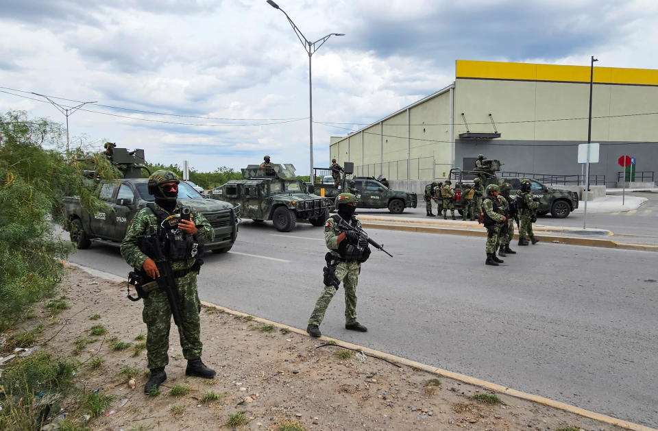Mexican soldiers keep watch at a crime scene where five men were killed following a chase by federal forces, in Nuevo Laredo, Mexico, May 18, 2023. / Credit: JASIEL RUBIO/REUTERS