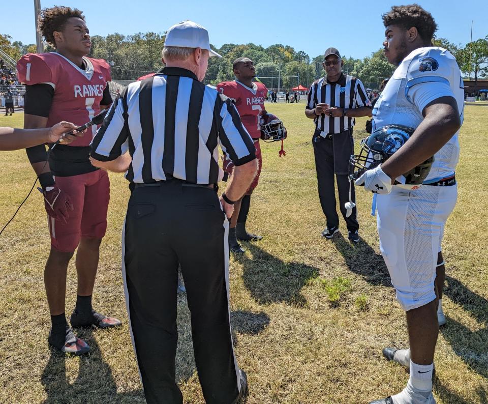 Raines and Ribault captains meet at midfield for the coin toss of the 2022 Northwest Classic.