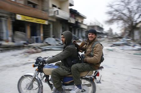 Fighters of the Kurdish People's Protection Units (YPG) patrol on a motorcycle in the streets of the northern Syrian town of Kobani January 28, 2015. REUTERS/Osman Orsal