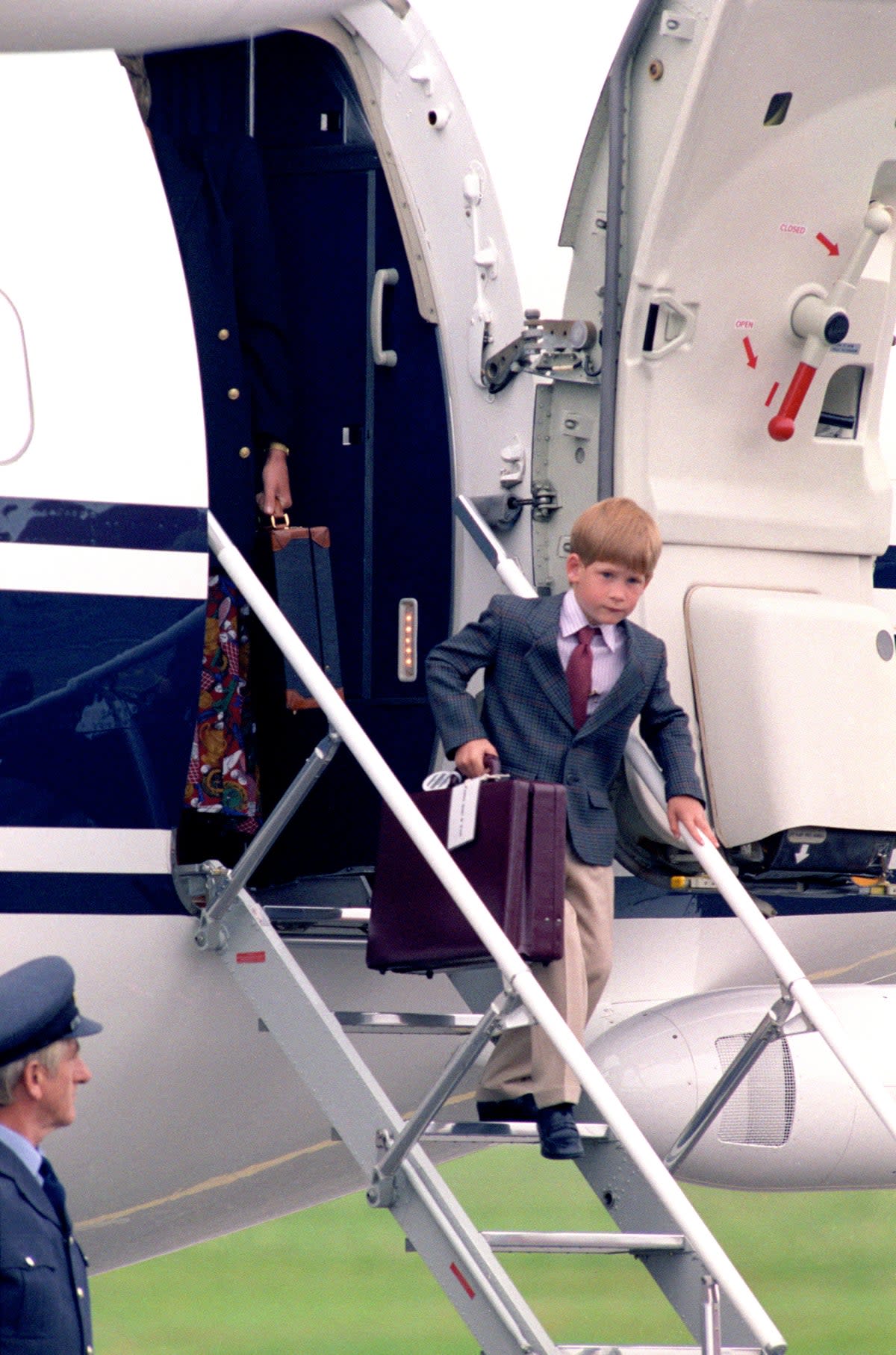 Duke of Sussex 40th birthday: <p>Harry, aged six, carries a briefcase down the down the steps of a plane in Scotland </p> (Chris Bacon/PA)