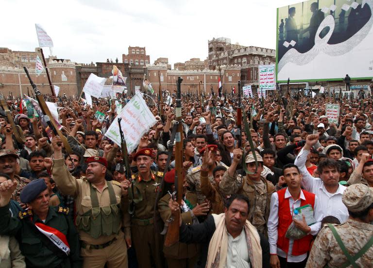 Members of the Yemeni security forces and tribal gunmen, both loyal to the Huthi movement, brandish their weapons on March 26, 2015 during a gathering in Sanaa to show support the Shiite Huthi militia and against the Saudi-led intervention