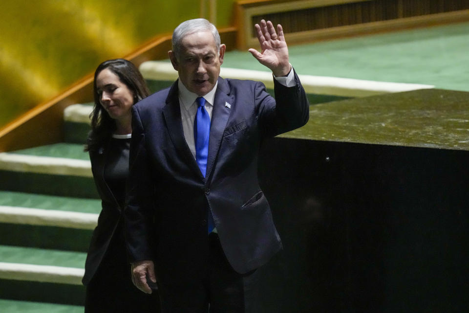 Israeli Prime Minister Benjamin Netanyahu waves at he is escorted from the stage by protocol after addressing the 78th session of the United Nations General Assembly, Friday, Sept. 22, 2023 at United Nations headquarters. (AP Photo/Mary Altaffer)