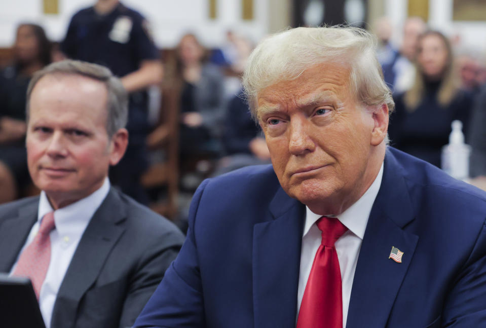 Former President Donald Trump sits in the courtroom with his legal team before the continuation of his civil business fraud trial at New York Supreme Court, Tuesday, Oct. 17, 2023, in New York. (Andrew Kelly/Pool Photo via AP)