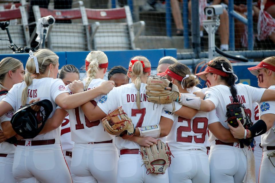 Alabama huddles before a softball game between Alabama and Stanford in the Women's College World Series at USA Softball Hall of Fame Stadium in  in Oklahoma City, Friday, June, 2, 2023. 
