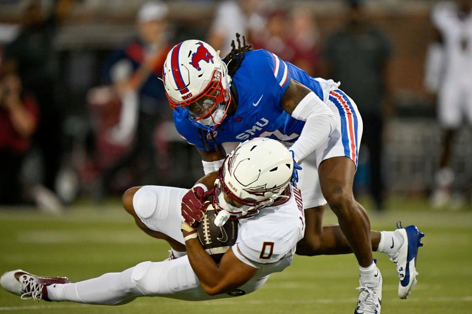 Sep 28, 2024; Dallas, Texas, USA; Southern Methodist Mustangs safety Brandon Crossley (1) tackles DUPLICATE***Florida State Seminoles defensive back Earl Little Jr. (0)***Florida State Seminoles wide receiver Ja'Khi Douglas (0) during the first quarter at Gerald J. Ford Stadium. Mandatory Credit: Jerome Miron-Imagn Images