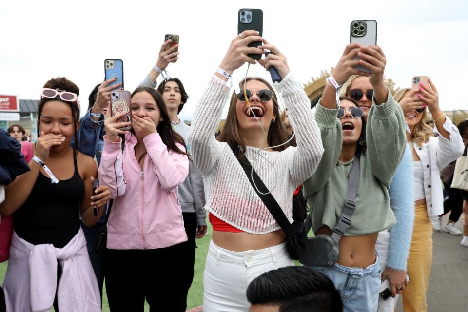 Fans use their smart phones to photograph cast members from the series "Outer Banks"