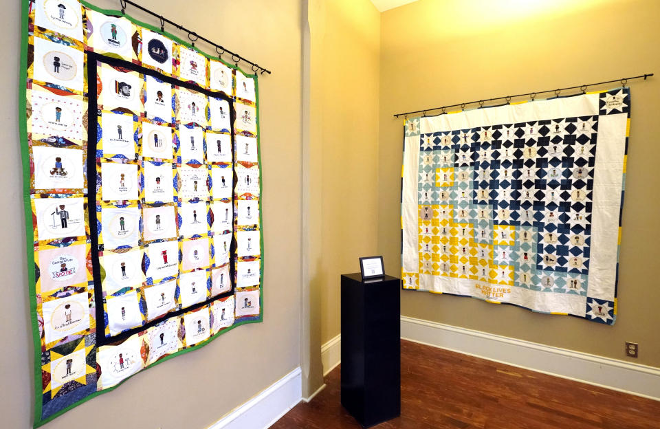 Two hand crafted quilts adorned with 116 cross-stitched portraits honoring African Americans who lost their lives to racial violence are photographed while on display at the Margaret Walker Center on the Jackson State University campus, Tuesday, Nov. 30, 2021, in Jackson, Miss. The quilts, stitched together by 75 artists from the U.S. and beyond, are part of the Stitch Their Name Memorial Project. (AP Photo/Rogelio V. Solis)