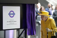 Britain's Queen Elizabeth II unveils a plaque to mark the Elizabeth line's official opening at Paddington station in London, Tuesday May 17, 2022, to mark the completion of London's Crossrail project. (Andrew Matthews/Pool via AP)