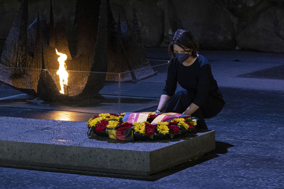 German Foreign Minister Annalena Baerbock lays a wreath at the Hall of Remembrance at the Yad Vashem Holocaust Memorial in Jerusalem, Thursday, Feb. 10, 2022. (AP Photo/Tsafrir Abayov)