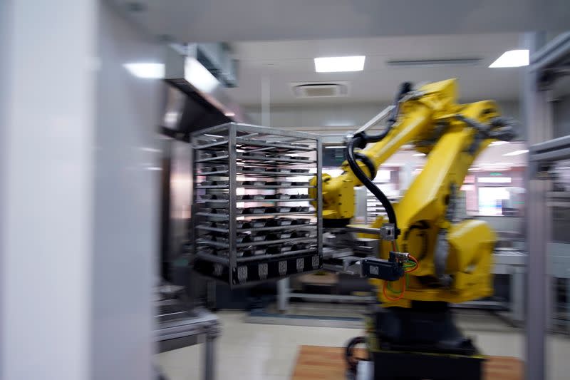 A robot chef makes food for lunch at Minhang Experimental High School amid the global outbreak of the coronavirus disease (COVID-19) in Shanghai