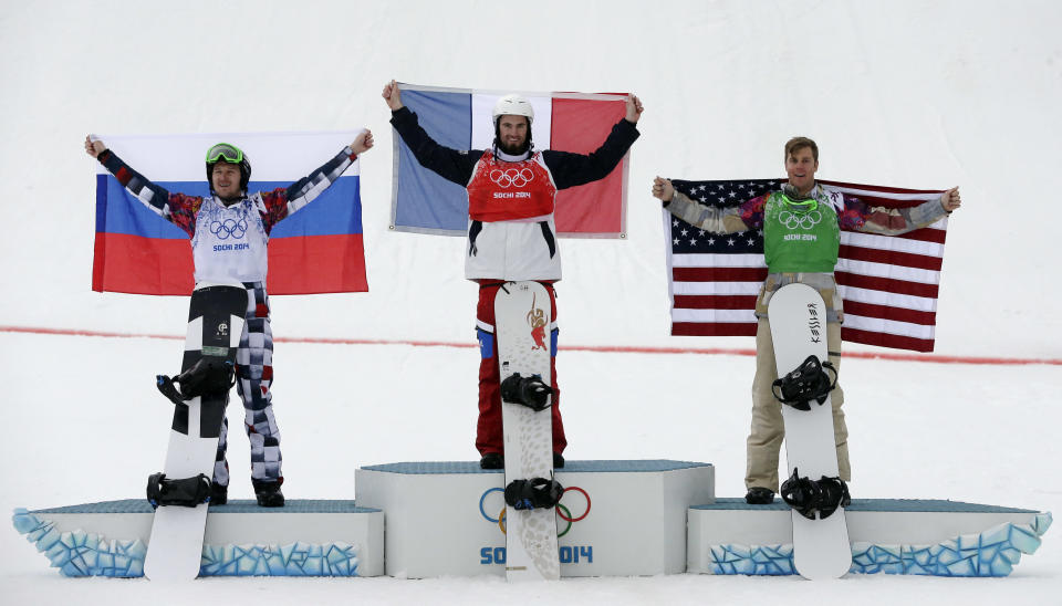 France's Pierre Vaultier, center, celebrates his gold medal with silver medalist Nikolai Olyunin of Russia, left, and bronze medalist Alex Deibold of the United States after the men's snowboard cross final at the Rosa Khutor Extreme Park, at the 2014 Winter Olympics, Tuesday, Feb. 18, 2014, in Krasnaya Polyana, Russia. (AP Photo/Andy Wong)