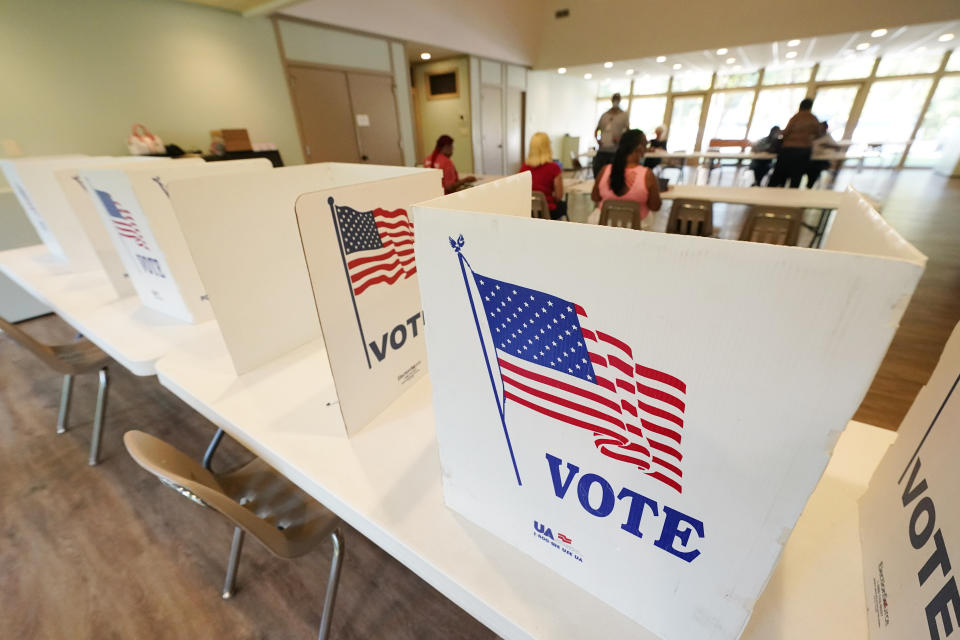 FILE - Empty poll kiosks await voters at the Mississippi Second Congressional District Primary election precinct June 7, 2022, in Jackson, Miss. Prosecutors are trying to stop the menacing of election workers as violent and graphic threats are deluging workers even in normally quiet periods between elections. (AP Photo/Rogelio V. Solis, File)