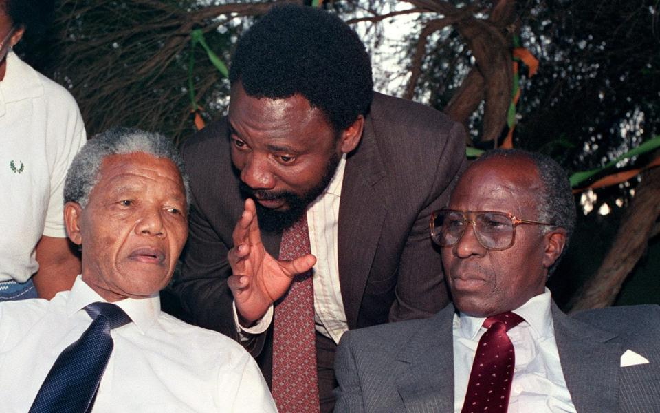 Cyril Ramaphosa speaks with Nelson Mandela (left) and former political prisoner Andrew Mlangeni (right) in 1990 - PHILIP LITTLETON/AFP via Getty Images