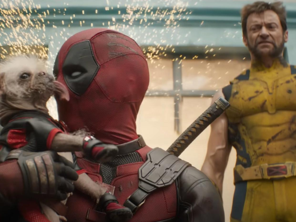 Ryan Reynolds with a puppy and Hugh Jackman as Deadpool and Wolverine, respectively, in “Deadpool & Wolverine.”