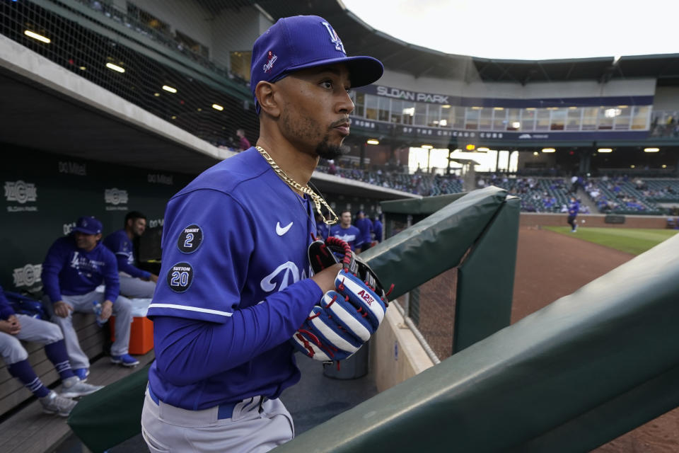 Los Angeles Dodgers right fielder Mookie Betts (50) leaves the dugout between innings of a spring training baseball game against the Chicago Cubs Thursday, March 25, 2021, in Mesa, Ariz. (AP Photo/Ashley Landis)