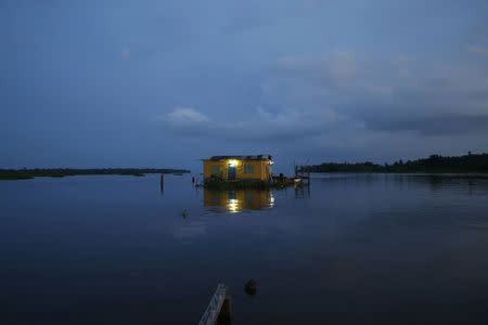A house stands on Lake Maracaibo in the village of Congo Mirador, where the Catatumbo River feeds into the lake, in the western state of Zulia October 22, 2014. REUTERS/Jorge Silva