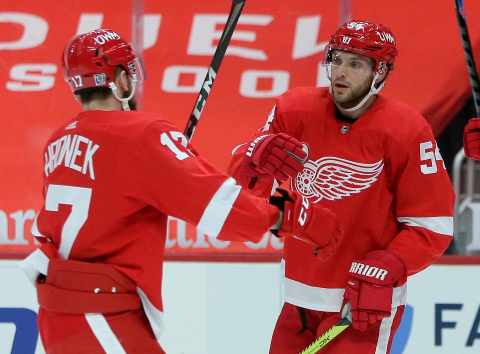 Detroit Red Wings defenseman Filip Hronek (17) celebrates with right wing Bobby Ryan (54) after a goal by Anthony Mantha during the second period of the team's NHL hockey game against the Columbus Blue Jackets on Tuesday, Jan. 19, 2021, in Detroit. Ryan also scored in the team's 3-2 overtime win.