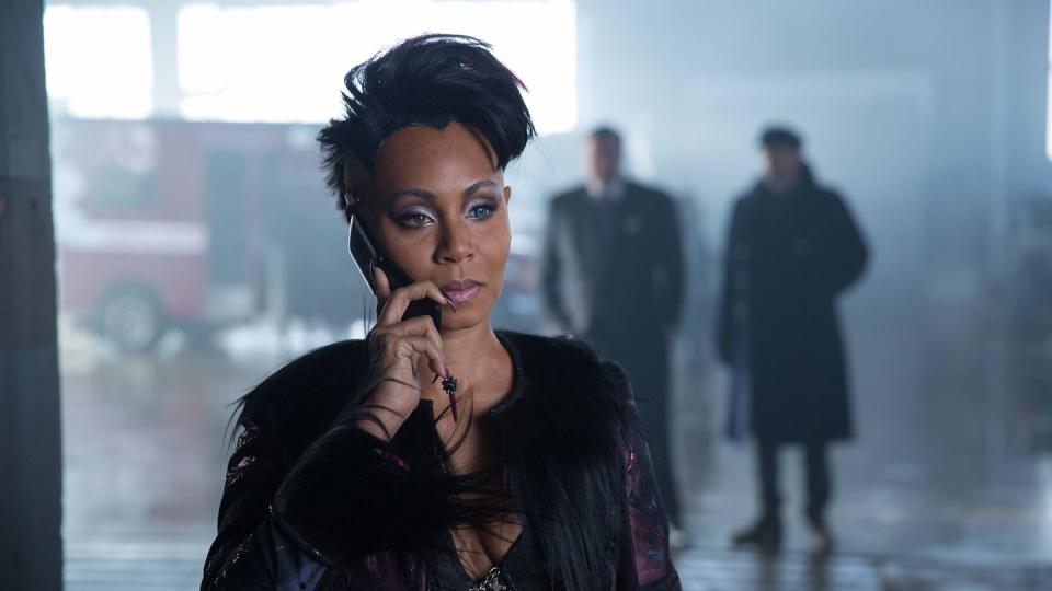 jada pinkett smith wearing a black outfit and speaking into a smartphone