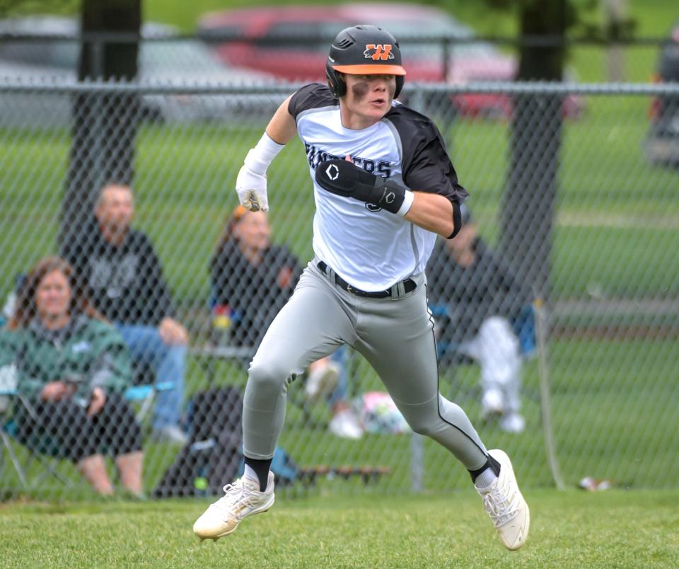 Washington's Easton Harris keeps an eye on the ball as he races down the third-base line for a score during a recent game against Springfield at Washington Community High School.