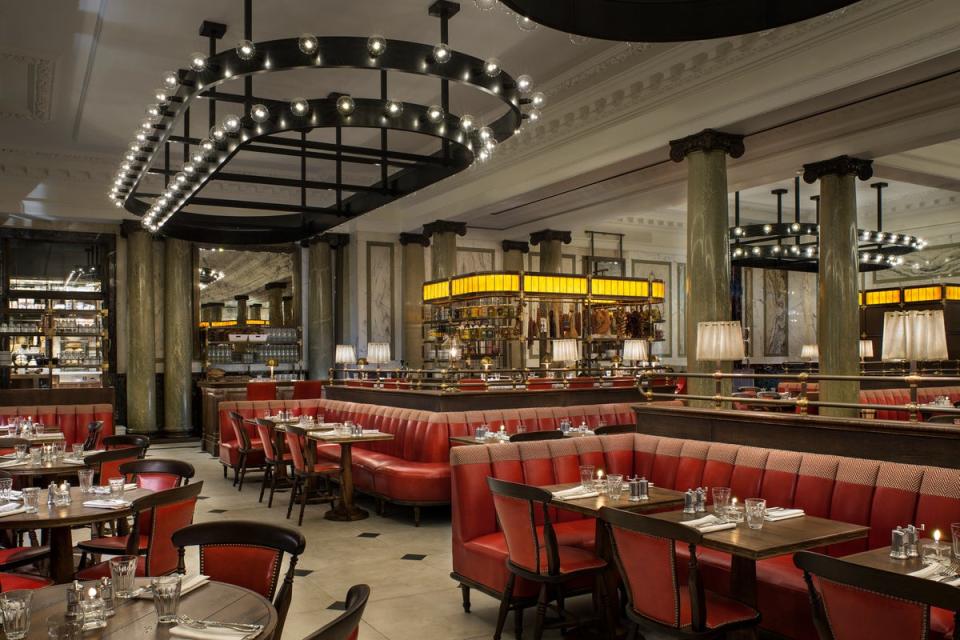 The Martin Brudnizki-designed Holborn Dining Room is a brasserie-style space, with red banquette seating and warm lighting above the gin bar (Handout)
