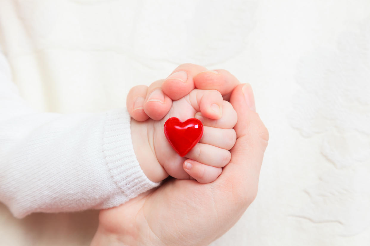 concept of love and family. hands of mother and baby closeup