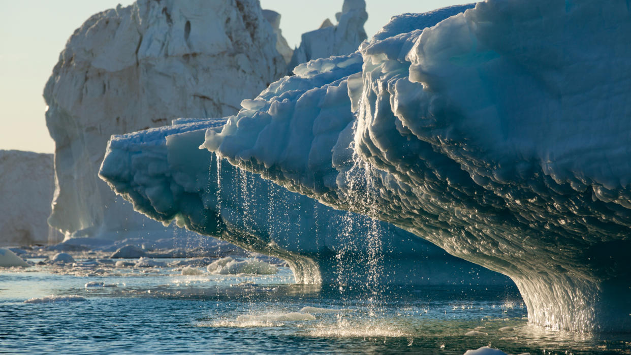  An iceberg melting and dripping water into the sea 