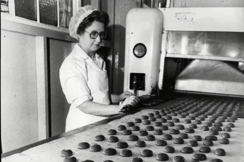 Mrs Olive Pearson operating a machine in the "enrobement" department at Hull sweet-makers, Needlers Ltd. Her job was to make sure the centres were properly coated with chocolate before going on to be "dressed" in foil