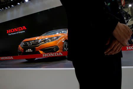 A security guard stands in front of a Honda's CIVIC model during the Auto China 2016 show in Beijing, China April 25, 2016. REUTERS/Kim Kyung-Hoon/File Photo