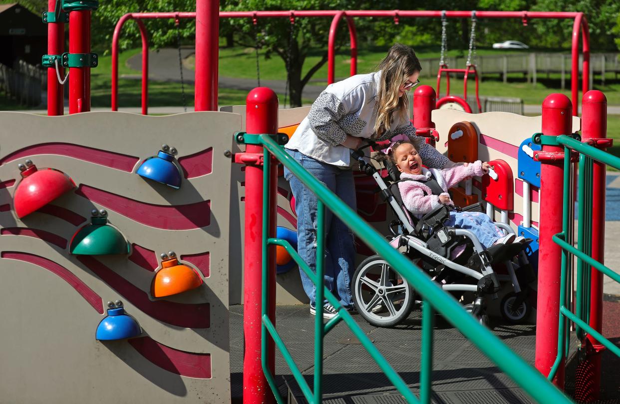 Hayley Hensal and her daughter Nyana, 4, play on some of the accessible playground equipment at SOAR Playground in Stow.
