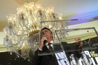 Brazil's right wing former President Jair Bolsonaro is seen through the podium as he speaks at an event hosted by conservative group Turning Point USA, at Trump National Doral Miami, Friday, Feb. 3, 2023, in Doral, Fla. (AP Photo/Rebecca Blackwell)