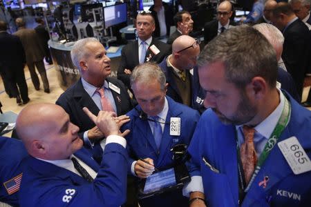 Traders work on the floor of the New York Stock Exchange (NYSE) as the market closes in New York, U.S., October 3, 2016. REUTERS/Lucas Jackson