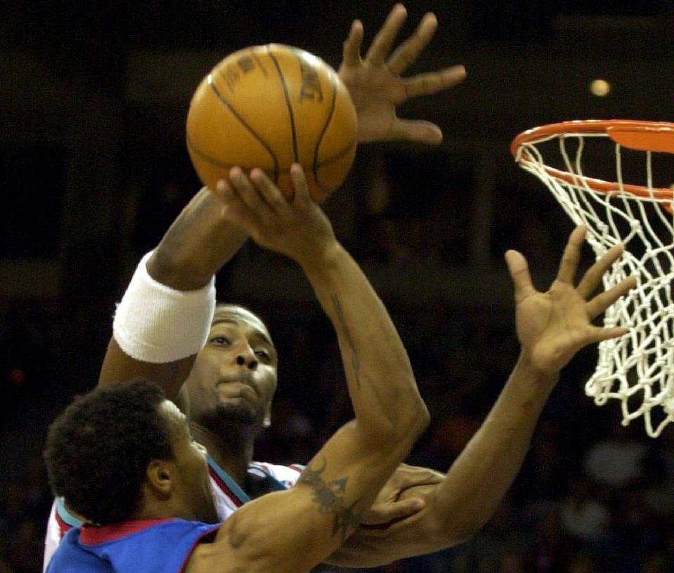 Nov. 1, 2001: Grizzlies center Lorenzen Wright defends against a shot attempt by Detroit's Dana Barros during the first half of the NBA team's Memphis debut at The Pyramid.