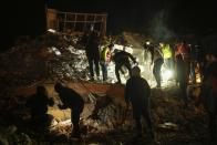 People and rescue teams search for people in destroyed buildings in Elbistan, southern Turkey, Wednesday, Feb. 8, 2023. With the hope of finding survivors fading, stretched rescue teams in Turkey and Syria searched Wednesday for signs of life in the rubble of thousands of buildings toppled by a catastrophic earthquake. (AP Photo/Francisco Seco)