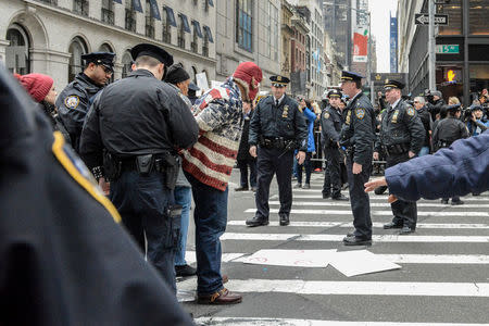 FILE PHOTO - A person is detained during a protest against U.S. President Donald Trump near Trump Tower in New York City, U.S. on January 20, 2017. REUTERS/Stephanie Keith/File Photo