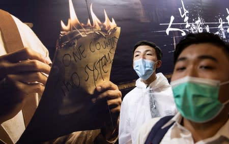 School students shout slogans as they boycott their classes to take part in a protest in Hong Kong