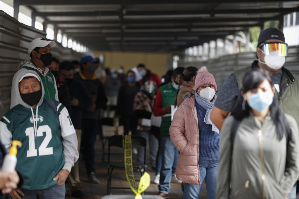 People wait in lines to get rapid COVID-19 tests at a health post set up by the city's Ministry of Health at the TAPO bus station in the Venustiano Carranza borough of Mexico City, Friday, Nov. 20, 2020. Mexico passed the 100,000 mark in confirmed COVID-19 deaths on Thursday, becoming only the fourth country to do so. (AP Photo/Rebecca Blackwell)