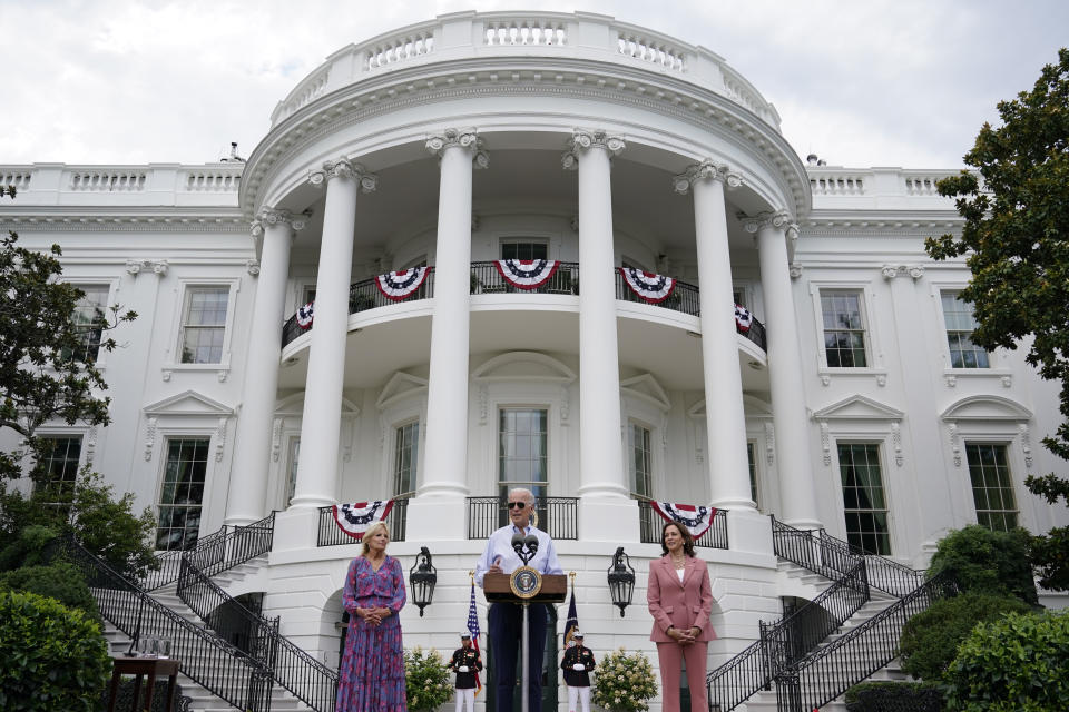 President Joe Biden speaks at the Congressional Picnic on the South Lawn of the White House, Tuesday, July 12, 2022, in Washington. First lady Jill Biden, left, and Vice President Kamala Harris, right, look on. (AP Photo/Patrick Semansky)