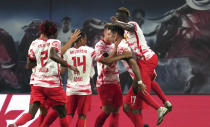 Leipzig's Dominik Szoboszlai, second right, celebrates with teammates after scoring the opening goal of the match during the German Bundesliga soccer match between RB Leipzig and VfB Stuttgart in Leipzig, Germany, Friday, Aug. 20, 2021. (AP Photo/Michael Sohn)